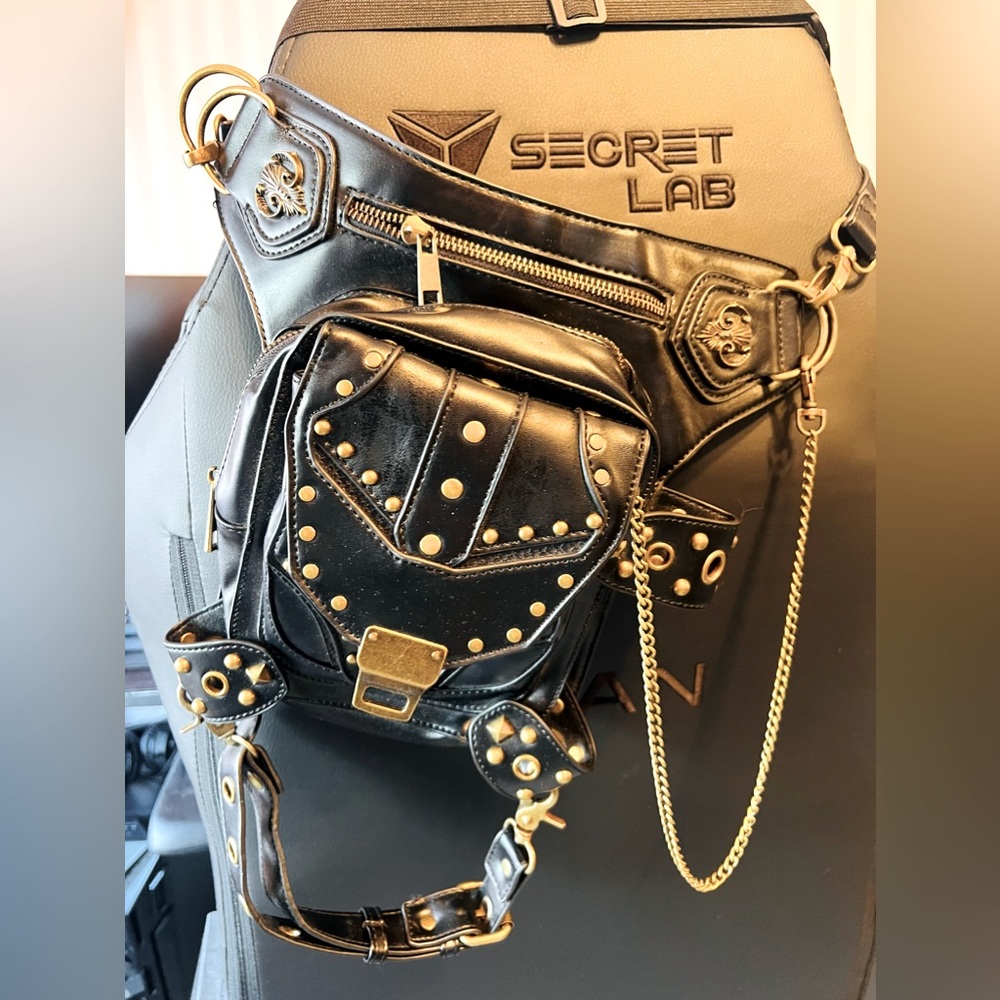 Black faux leather fanny pack with gold rivets.
